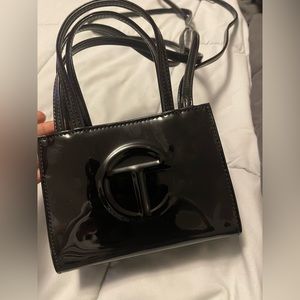 I am selling a small black leather Telfar purse that has never been used.